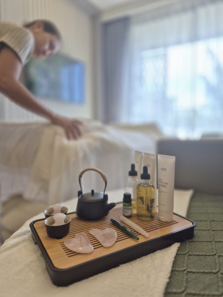 A skilled female therapist preparing an in-home facial treatment in Phuket